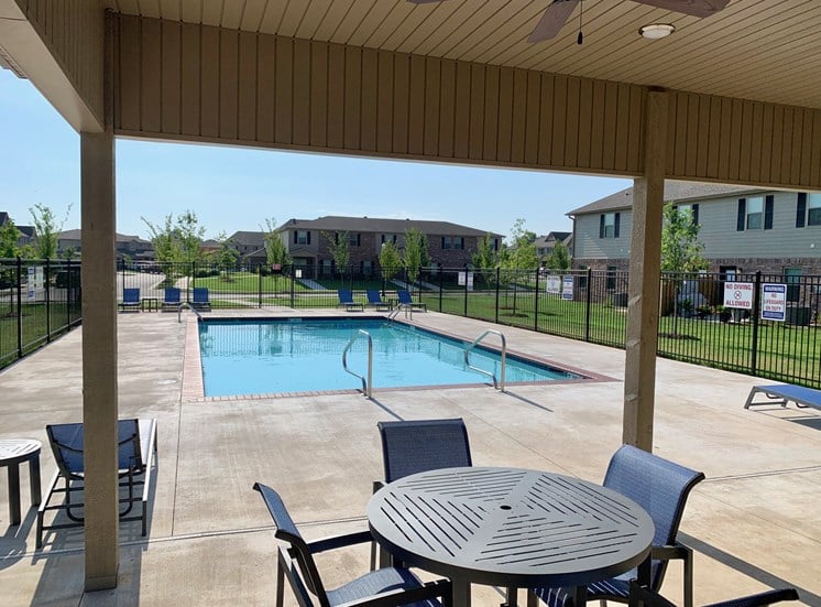 Community Pool and patio with table and chairs